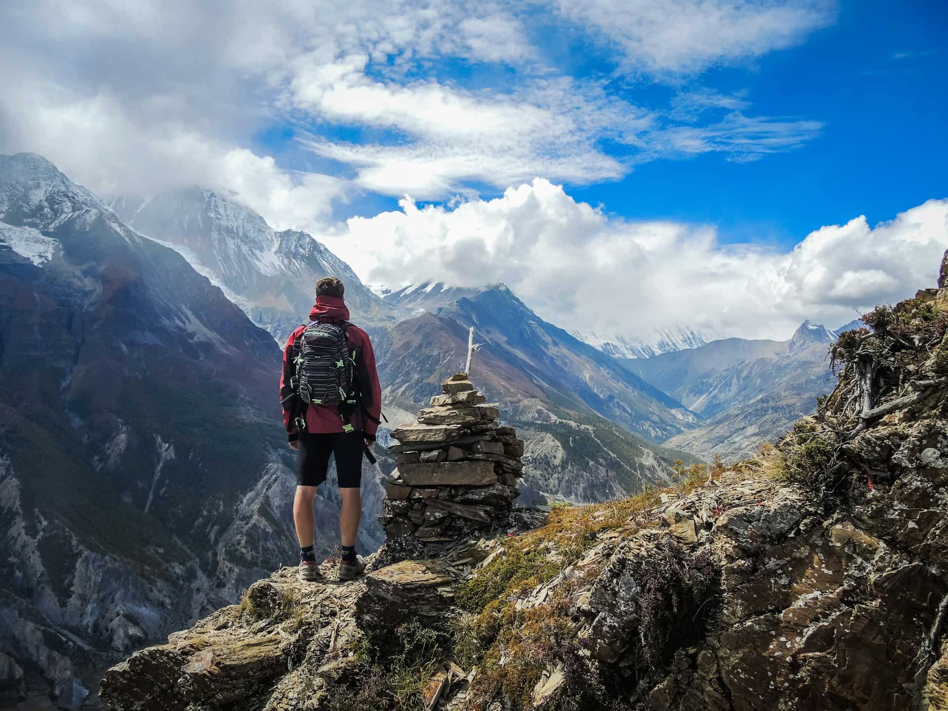 Trekkers Exploring Mountain Trails with Cloud Covered Peaks